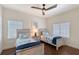 Charming bedroom features two twin beds with nautical-themed bedding and a ceiling fan at 4108 Roberts Point Rd, Sarasota, FL 34242