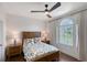 Inviting bedroom boasts wood floors, a ceiling fan, and lots of natural light at 4108 Roberts Point Rd, Sarasota, FL 34242