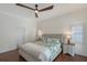 Comfortable bedroom with a ceiling fan, hardwood floors, and decorative pillows on the bed at 4108 Roberts Point Rd, Sarasota, FL 34242