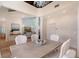 Open dining room with tall ceilings offering views of the living room and upstairs at 4108 Roberts Point Rd, Sarasota, FL 34242