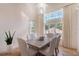 Bright dining room with decorative chandelier and view to outside pool area at 4108 Roberts Point Rd, Sarasota, FL 34242