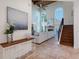 Bright entryway with staircase leading to the second floor with views into the living room at 4108 Roberts Point Rd, Sarasota, FL 34242