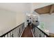 Hallway leading to a home office with dark wood floors and wrought iron railing at 4108 Roberts Point Rd, Sarasota, FL 34242