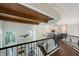 Spacious hallway overlooking the living room, with a fireplace and large windows at 4108 Roberts Point Rd, Sarasota, FL 34242