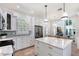 Open concept kitchen with a center island, stainless steel appliances, and adjacent dining area at 4108 Roberts Point Rd, Sarasota, FL 34242