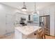Well-equipped kitchen with a center island, stainless steel appliances, and tile backsplash at 4108 Roberts Point Rd, Sarasota, FL 34242