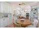 Charming eat-in kitchen featuring a crystal chandelier and stainless steel appliances at 4108 Roberts Point Rd, Sarasota, FL 34242