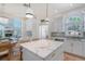 Bright kitchen with white cabinetry, stone countertops, and pendant lighting at 4108 Roberts Point Rd, Sarasota, FL 34242