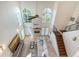 High angle view of a spacious living room featuring a fireplace, staircase, and soaring windows at 4108 Roberts Point Rd, Sarasota, FL 34242