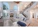 Comfortable living room with a fireplace, staircase, and lots of natural light at 4108 Roberts Point Rd, Sarasota, FL 34242