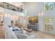 Bright living room with high ceilings, modern decor, and a view of the kitchen and dining area at 4108 Roberts Point Rd, Sarasota, FL 34242