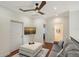 Bright living room features wood floors, a ceiling fan, and a comfortable sofa at 4108 Roberts Point Rd, Sarasota, FL 34242