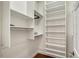 Organized walk-in closet with built-in shelves and hanging rods for ample storage at 4108 Roberts Point Rd, Sarasota, FL 34242