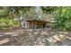 Wood-sided home with covered patio and wooded lot provides backyard privacy at 4122 Old Bradenton Rd, Sarasota, FL 34234