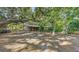 Spacious backyard with a charming house, lush trees, and shaded areas, creating a serene outdoor space at 4122 Old Bradenton Rd, Sarasota, FL 34234