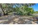Expansive backyard framed by trees, a chain-link fence, and providing a sense of privacy and space at 4122 Old Bradenton Rd, Sarasota, FL 34234