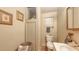 Compact bathroom with cream walls, a toilet, sink, and vintage accents at 4122 Old Bradenton Rd, Sarasota, FL 34234