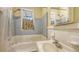 Bathroom featuring a tub and shower combination, with grey tile backsplash and sink at 4122 Old Bradenton Rd, Sarasota, FL 34234