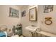 Small bathroom featuring a vintage sink, toilet, and wicker storage, needing upgrades at 4122 Old Bradenton Rd, Sarasota, FL 34234