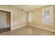 This bedroom features two windows with tiled flooring and neutral wall color at 4122 Old Bradenton Rd, Sarasota, FL 34234