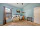 Cozy bedroom with light blue walls, wood floors, a window, and vintage dresser at 4122 Old Bradenton Rd, Sarasota, FL 34234