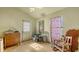 This bedroom includes wood floors, olive green walls, and needs updating at 4122 Old Bradenton Rd, Sarasota, FL 34234