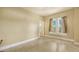 Neutral bedroom showcasing an interior view of a door frame leading to another room and a window with curtains at 4122 Old Bradenton Rd, Sarasota, FL 34234
