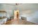 Modest bedroom features wood floors, neutral paint, and a glimpse into an adjoining space at 4122 Old Bradenton Rd, Sarasota, FL 34234