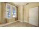 Sunlit bedroom featuring tiled floors, soft curtains, and neutral color scheme at 4122 Old Bradenton Rd, Sarasota, FL 34234