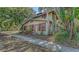 Classic two-story home with colorful trim, surrounded by greenery, and offering a welcoming facade at 4122 Old Bradenton Rd, Sarasota, FL 34234