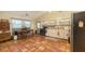 The kitchen offers terracotta flooring, a dining table, and stainless steel appliances at 4122 Old Bradenton Rd, Sarasota, FL 34234