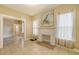 This living room showcases a fireplace, tile floors, and views to other rooms at 4122 Old Bradenton Rd, Sarasota, FL 34234