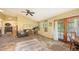 The open living room has a high ceiling, ample sunlight, and French doors at 4122 Old Bradenton Rd, Sarasota, FL 34234