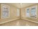 Empty room with three windows and tiled floor at 4122 Old Bradenton Rd, Sarasota, FL 34234