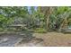 Picturesque yard showcases verdant trees and a charming two-story home, creating a delightful outdoor ambiance at 4122 Old Bradenton Rd, Sarasota, FL 34234