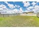 Spacious backyard with lush green grass and a white privacy fence at 4206 Park Willow Ave, Palmetto, FL 34221