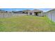Large grassy backyard is enclosed with a white privacy fence at 4206 Park Willow Ave, Palmetto, FL 34221