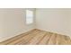 Bright bedroom features wood-look floors and a window with blinds at 4206 Park Willow Ave, Palmetto, FL 34221
