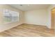 An empty bedroom with wood floors, a bright window, and an ensuite bath with a shower at 4206 Park Willow Ave, Palmetto, FL 34221