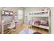 Staged bedroom with bunk beds, desk and stylish decor at 4206 Park Willow Ave, Palmetto, FL 34221