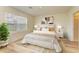 Comfortable bedroom with a queen bed, white bedding, neutral accents, and a bright window at 4206 Park Willow Ave, Palmetto, FL 34221
