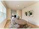 Bright dining room featuring a wooden table with white chairs and stylish modern art at 4206 Park Willow Ave, Palmetto, FL 34221