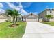 Charming one-story home featuring a well-manicured lawn, a two-car garage, and a freshly sealed concrete driveway at 4206 Park Willow Ave, Palmetto, FL 34221