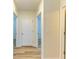 Hallway displaying multiple doorways with white trim and wood-look flooring at 4206 Park Willow Ave, Palmetto, FL 34221