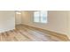 Bright room featuring stylish flooring, a large window, and a doorway at 4206 Park Willow Ave, Palmetto, FL 34221