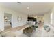 Cozy living room open to the kitchen, featuring a plush sofa and modern decor at 4206 Park Willow Ave, Palmetto, FL 34221