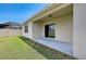 Covered patio with sliding door overlooks the grassy backyard at 4206 Park Willow Ave, Palmetto, FL 34221