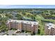 An aerial view shows an available unit at a condo community near a pond and golf course at 4570 Pinebrook Cir # 508, Bradenton, FL 34209
