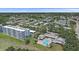 Aerial perspective showcases a community with a pool, clubhouse, manicured grounds, and nearby golf course at 4570 Pinebrook Cir # 508, Bradenton, FL 34209