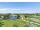 Scenic aerial view featuring the golf course, ponds, lush landscaping and nearby condos at 4570 Pinebrook Cir # 508, Bradenton, FL 34209